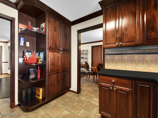 kitchen featuring backsplash and crown molding