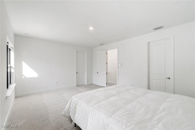 bedroom featuring light colored carpet