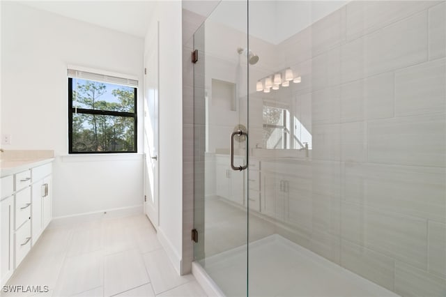 bathroom with vanity, tile patterned floors, and a shower with door