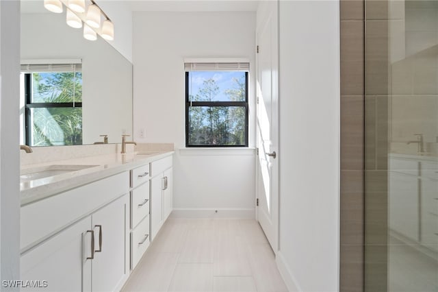 bathroom with vanity, tile patterned floors, and a healthy amount of sunlight