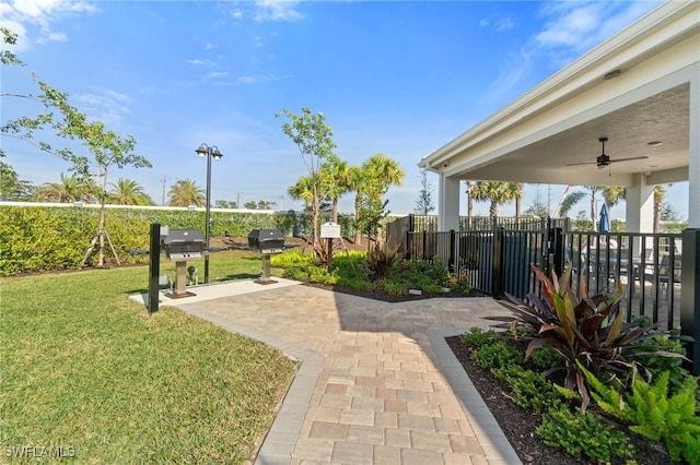 view of yard with ceiling fan and a patio