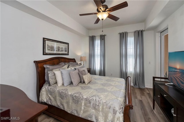 bedroom with ceiling fan and light wood-type flooring