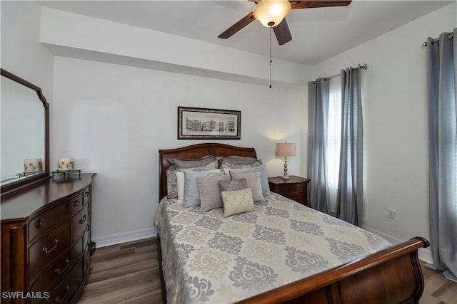 bedroom featuring ceiling fan and dark wood-type flooring