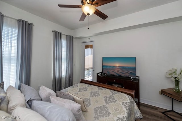 bedroom featuring multiple windows, ceiling fan, and dark wood-type flooring