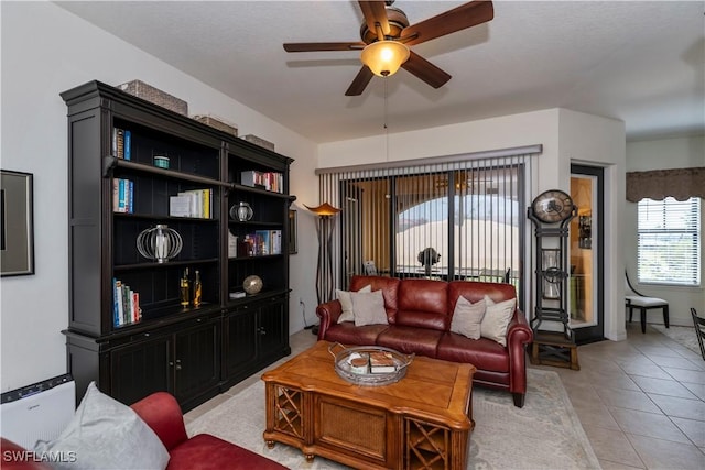 living room featuring ceiling fan and light tile patterned floors