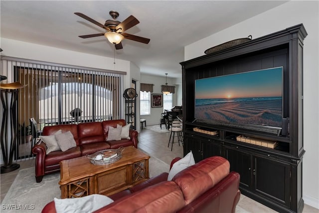 tiled living room with ceiling fan