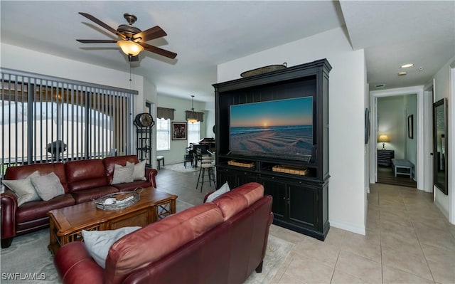 living room with ceiling fan and light tile patterned floors