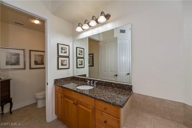 bathroom with tile patterned floors, vanity, and toilet