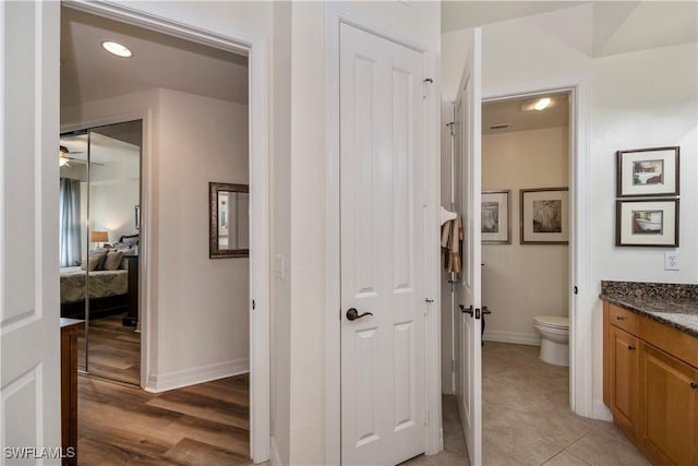 bathroom with tile patterned floors, vanity, and toilet