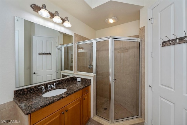 bathroom featuring vanity and a shower with door