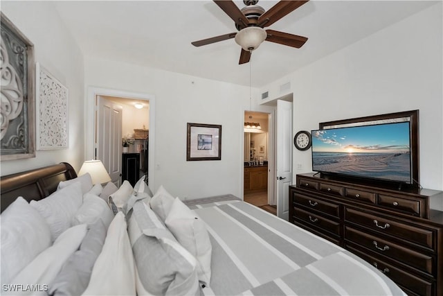 bedroom featuring ensuite bathroom, ceiling fan, a walk in closet, and a closet