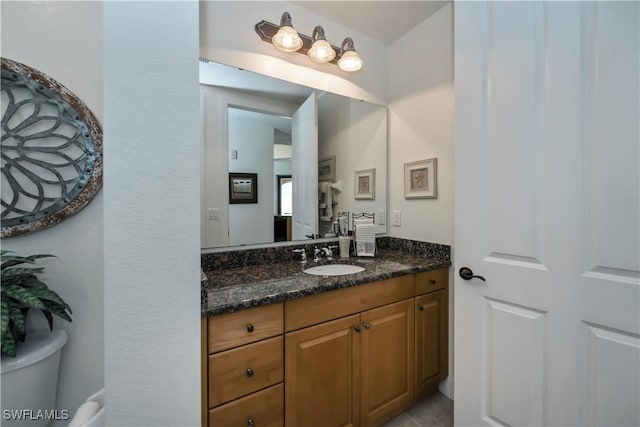 bathroom with vanity and toilet