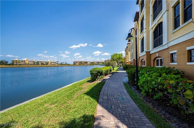 view of home's community with a yard and a water view