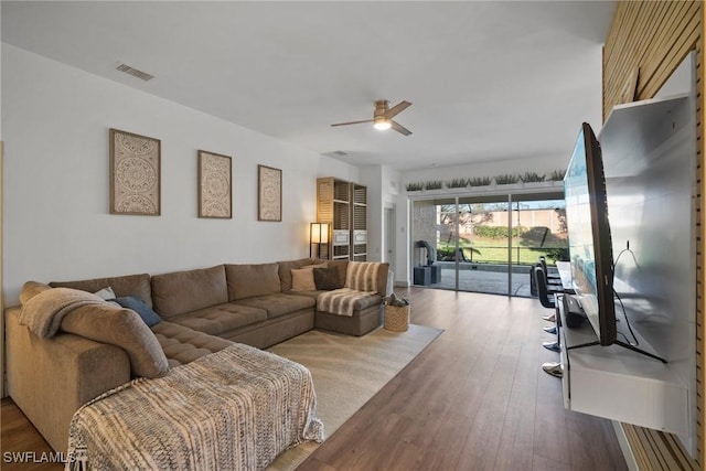 living room featuring ceiling fan and wood-type flooring