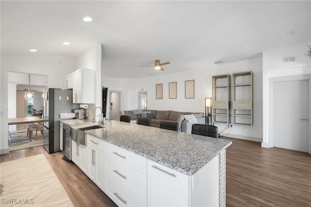 kitchen featuring white cabinets, sink, ceiling fan, light stone counters, and stainless steel appliances