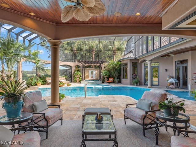 view of swimming pool with a lanai, a patio area, ceiling fan, and pool water feature