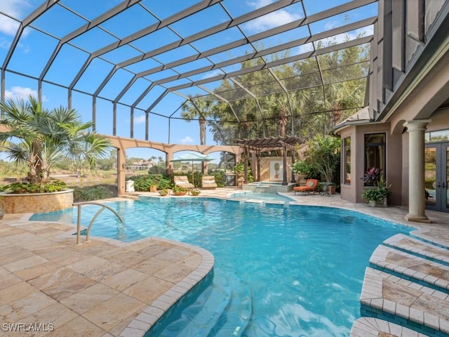 view of swimming pool with glass enclosure, a patio area, an in ground hot tub, and french doors