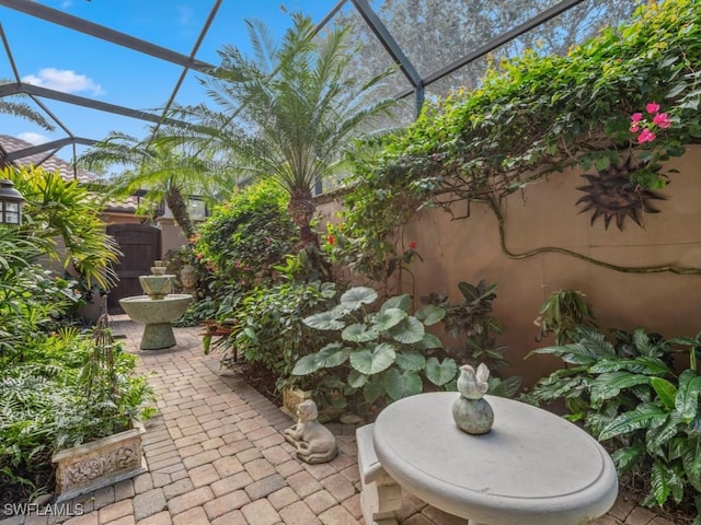 view of patio featuring a lanai