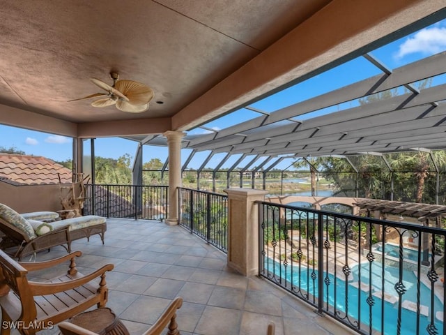 exterior space featuring ornate columns and ceiling fan