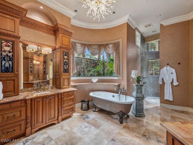 bathroom with a bathing tub, vanity, an inviting chandelier, and ornamental molding