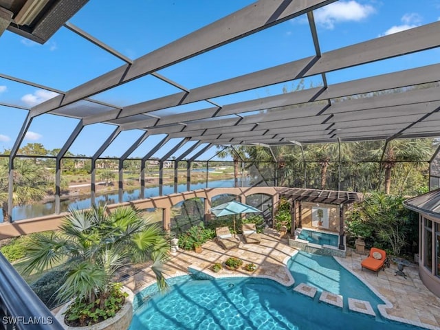 view of swimming pool with glass enclosure, a patio area, a water view, and an in ground hot tub