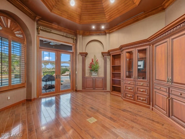 interior space with wood ceiling, crown molding, and french doors