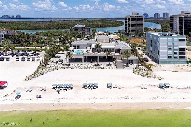 bird's eye view with a water view and a beach view