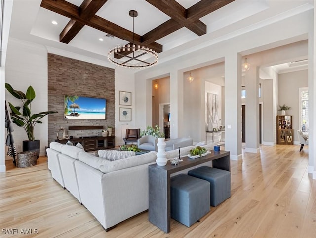 living room with beamed ceiling, light hardwood / wood-style floors, and coffered ceiling