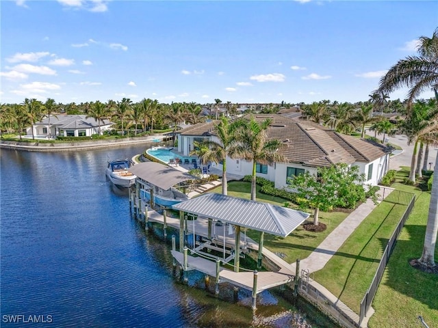 view of dock with a yard and a water view