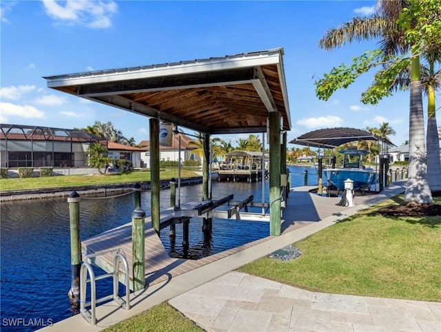 dock area featuring a lawn and a water view