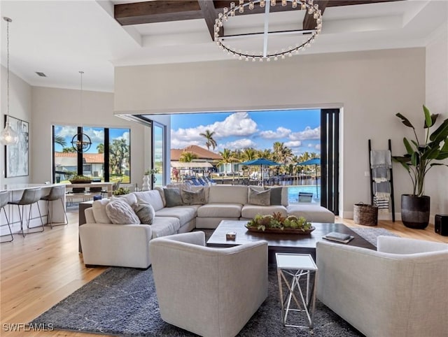 living room featuring coffered ceiling, hardwood / wood-style flooring, and beamed ceiling