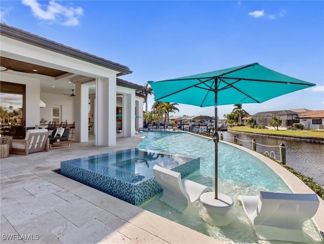 view of swimming pool with a patio, an in ground hot tub, and a water view