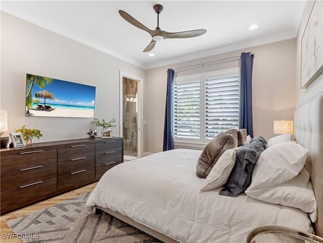 bedroom with light hardwood / wood-style flooring, ceiling fan, crown molding, and connected bathroom