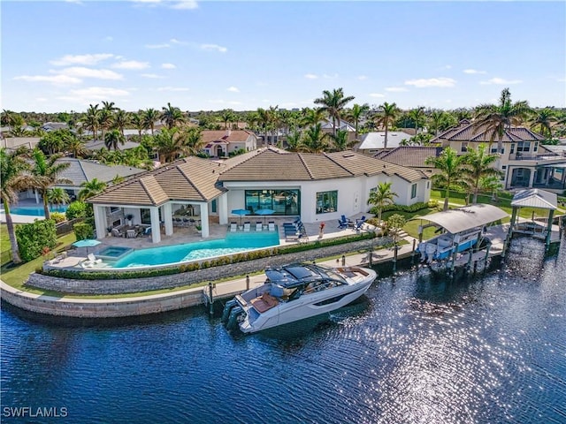 rear view of house featuring a patio and a water view