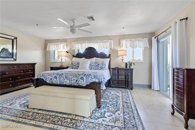 tiled bedroom featuring ceiling fan, access to exterior, and multiple windows