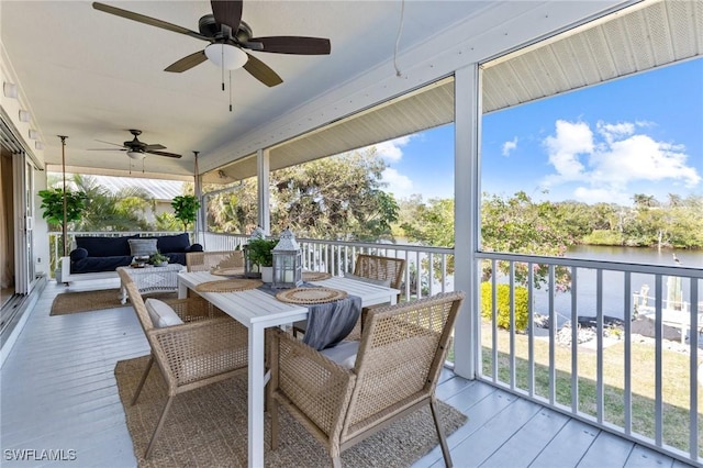 deck with an outdoor hangout area, ceiling fan, and a water view