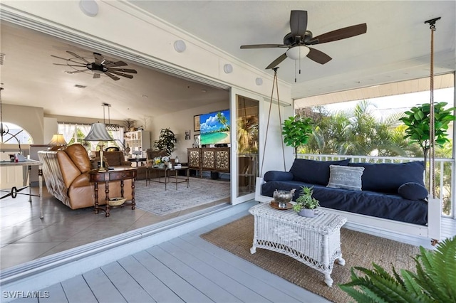 wooden deck with ceiling fan and an outdoor hangout area