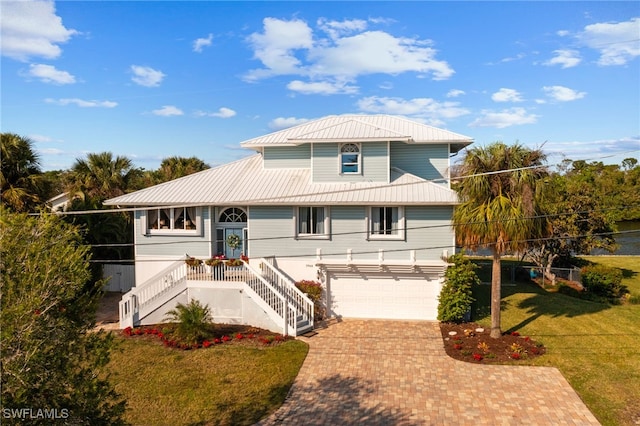 view of front of property with a front lawn and a garage