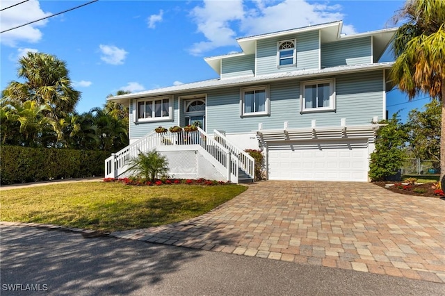 view of front of house featuring a front yard and a garage