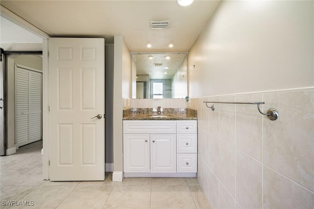 3968 Aloha Ln, Bonita Springs, FL 34134 - bathroom featuring vanity, wainscoting, and tile patterned flooring