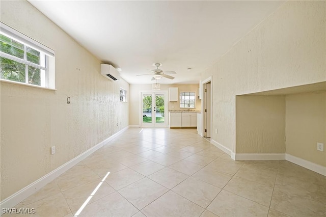 3968 Aloha Ln, Bonita Springs, FL 34134 - spare room with an AC wall unit, french doors, light tile patterned floors, and a ceiling fan