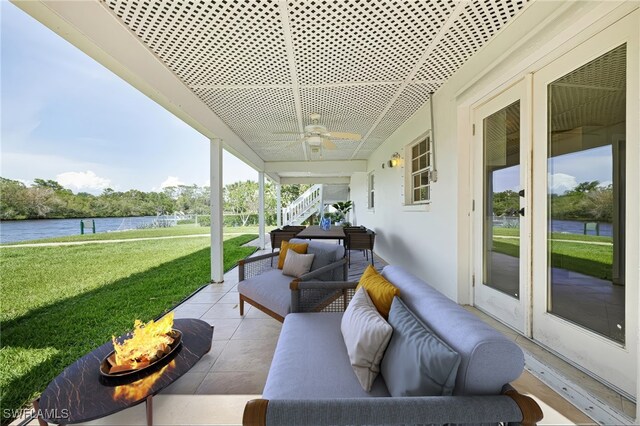 3968 Aloha Ln, Bonita Springs, FL 34134 - view of patio featuring a water view, ceiling fan, stairway, and an outdoor living space with a fire pit