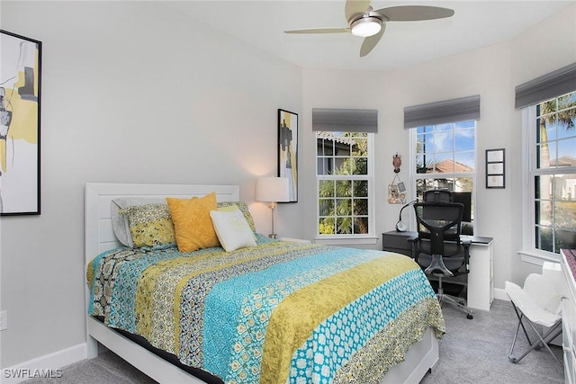 carpeted bedroom with ceiling fan and baseboards