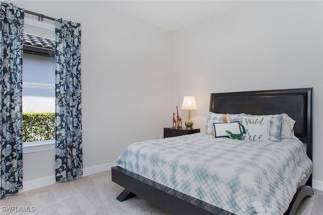 carpeted bedroom with baseboards