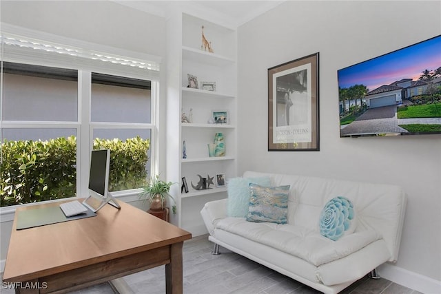 home office featuring built in features and wood finished floors