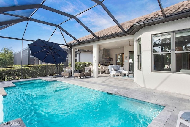 pool with glass enclosure, an outdoor hangout area, and a patio