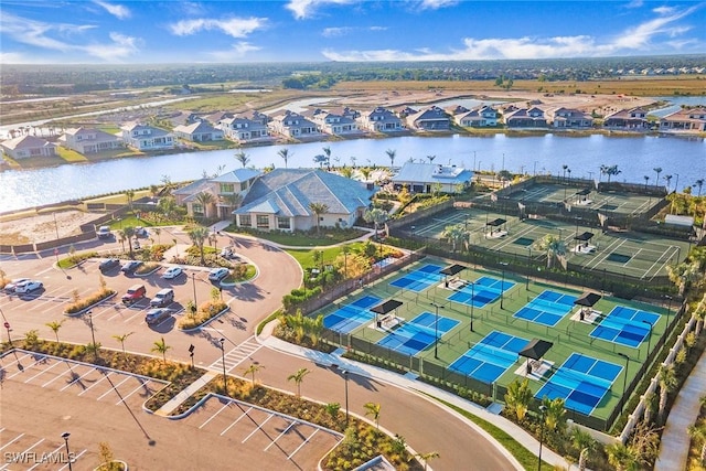 birds eye view of property with a water view and a residential view