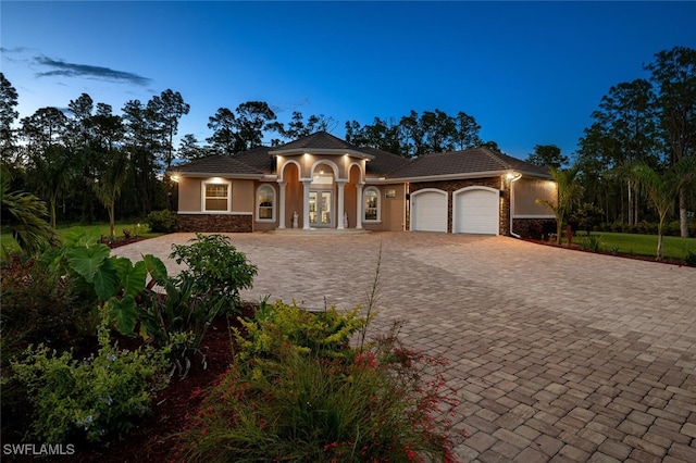 mediterranean / spanish house with a garage