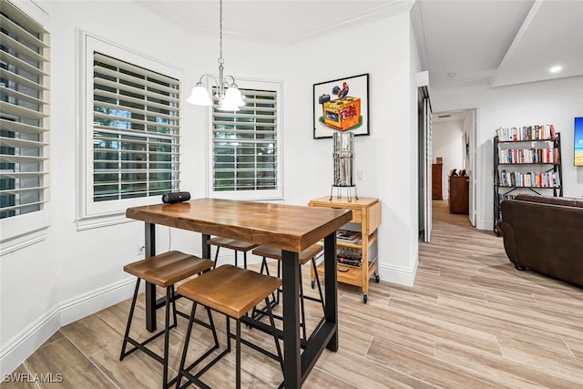 dining area featuring ornamental molding and a chandelier