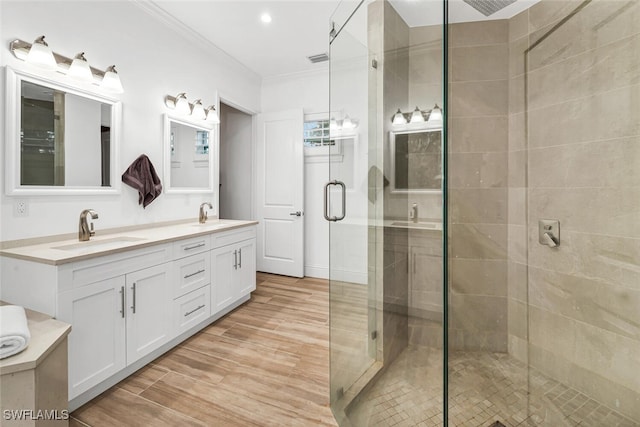 bathroom featuring crown molding, vanity, and walk in shower